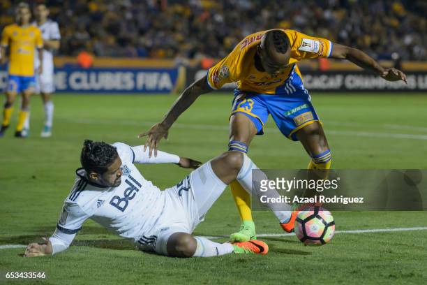 Luis Quinones of Tigres fights for the ball with Sheanon Williams of Vancouver Whitecaps during the semifinals first leg match between Tigres UANL...