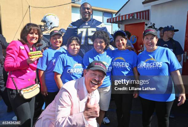 Pink's Co-Owner Gloria Pink, Co-Owner Richard Pink and tackle Chris Hairston pose with Pink's Hot Dogs staff at the unveiling of the "Chargers Chilli...