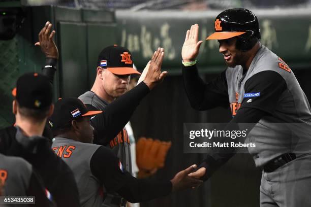 Outfielder Wladimir Balentien of the Netherlands celebrates with his team mates after scoring a run by a two run single of Infielder Yurendell de...