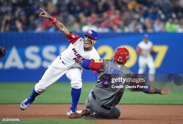 Javier Baez the Puerto Rico tags out Nelson Cruz of the Dominican Republic as he tries to steal second base during the eighth inning of the World...