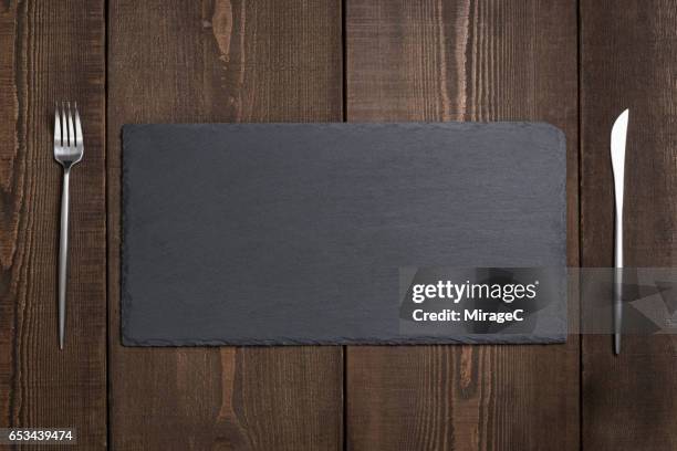 empty black stone tray plate - schist stock-fotos und bilder