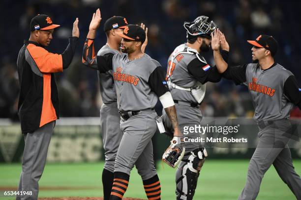 Infielder Yurendell de Caster of the Netherlands celebrates with his team mates after their 14-1 win in the World Baseball Classic Pool E Game Five...