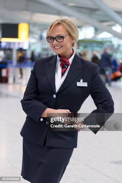 In this image released by British Airways today, March 15th 2017, in London, England, Emma Bunton assists British Airways passengers at Heathrow T5,...