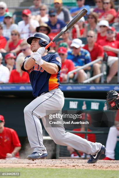 Max Stassi of the Houston Astros hits the ball against the St Louis Cardinals in the seventh inning during a spring training game at Roger Dean...