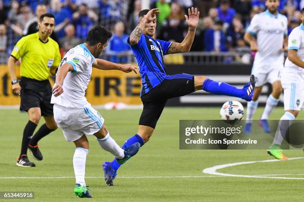 Midfielder Adrian Arregui trying to stop a shot from Midfielder Nicolas Lodeiro during the Seattle Sounders FC versus the Montreal Impact game on...