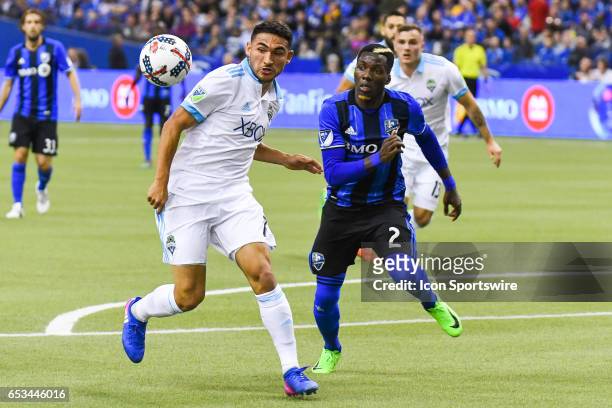 Midfielder Cristian Roldan looking at the ball and chased by Defender Ambroise Oyongo during the Seattle Sounders FC versus the Montreal Impact game...