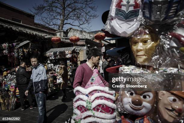 Pedestrians walk through a market street in the Wangfujing district of Beijing, China, on Tuesday, March 14, 2017. China has championed free trade...