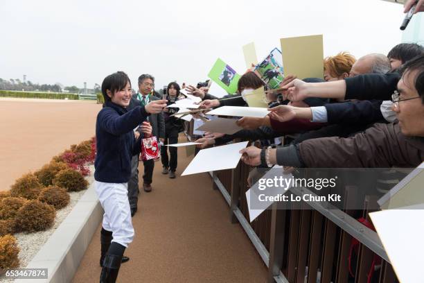 New JRA jockey Nanako Fujita gives her autograph to Japanese racing fans at Nakayama Racecourse on March 5, 2016 in Funabashi, Chiba, Japan. Nanako...