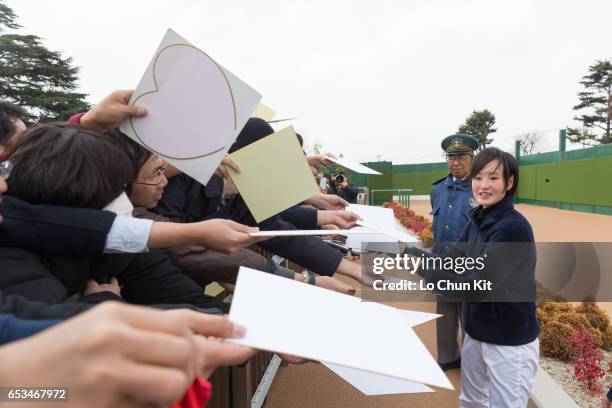 New JRA jockey Nanako Fujita gives her autograph to Japanese racing fans at Nakayama Racecourse on March 5, 2016 in Funabashi, Chiba, Japan. Nanako...