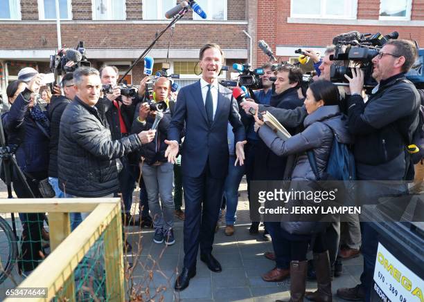 Netherlands' prime minister and VVD party leader Mark Rutte arrives to cast his ballot for Dutch general elections at a polling station on March 15,...