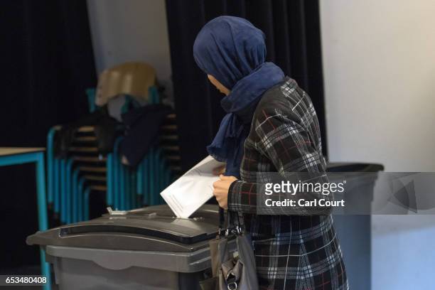 Woman in a headscarf casts her vote in the Dutch general election, on March 15, 2017 in The Hague, Netherlands. Dutch voters go to the polls today in...