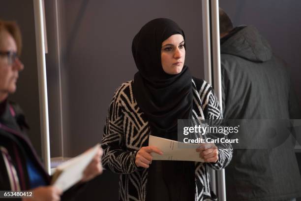 Woman in a headscarf casts her vote in the Dutch general election, on March 15, 2017 in The Hague, Netherlands. Dutch voters go to the polls today in...