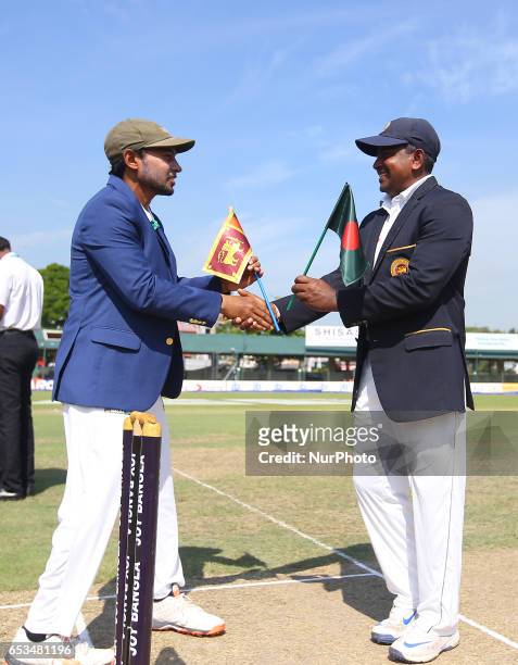 Sri Lanka's captain Rangana Herath shakes hands with Bangladesh captain Mushfiqur Rahim before the start of the first day of the second and final...