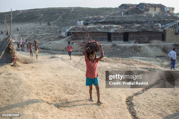 Refugee girl going back to her makeshift cam after collecting some firewood in Kutapalong expanded Rohingya refugee camp on March 4, 2017 in Cox's...