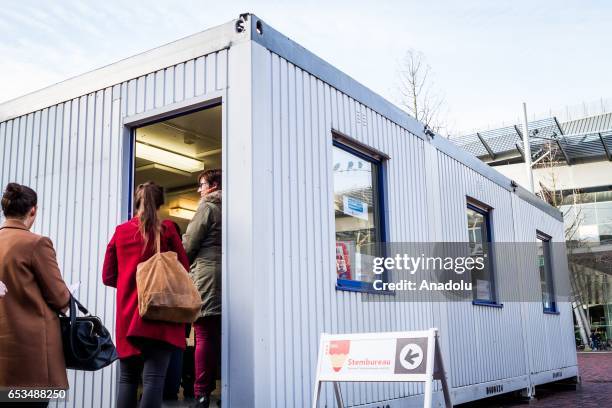 People stand and line up to vote for the second Chamber elections outside of the Amsterdam Bijlmer Arena Stadium, in Amsterdam, Netherlands on March...