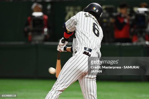 Infielder Hayato Sakamoto of Japan hits a single in the bottom of the second inning during the World Baseball Classic Pool E Game Six between Israel...