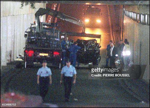 The wreckage of Princess Diana's car is lifted on a truck 31 August in the Alma tunnel of Paris. Princess Diana died a few hours after the crash at...