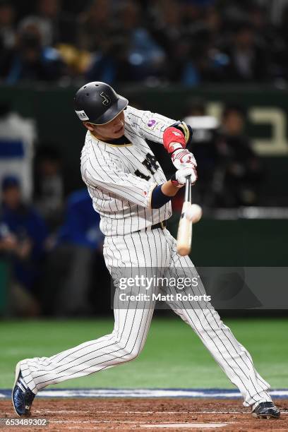 Infielder Hayato Sakamoto of Japan hits a single in the bottom of the second inning during the World Baseball Classic Pool E Game Six between Israel...