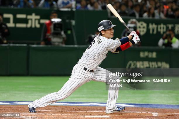 Infielder Hayato Sakamoto of Japan hits a single in the bottom of the second inning during the World Baseball Classic Pool E Game Six between Israel...