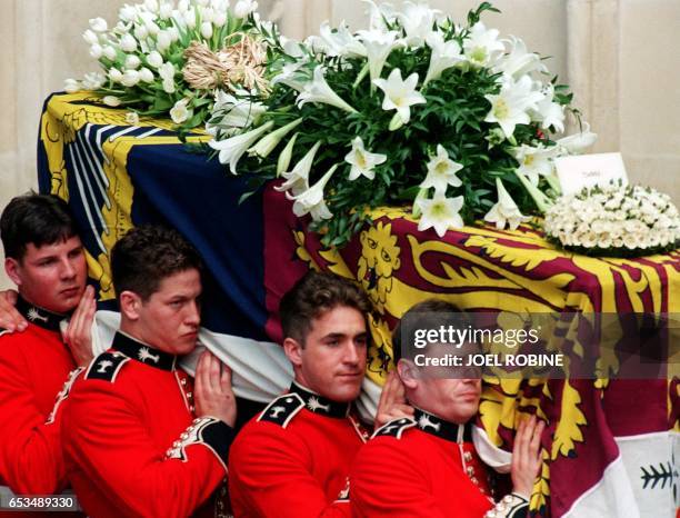 The coffin of Diana, Princess of Wales, is carried by a bearer party of Welsh Guards as it leaves Westminster Abbey in London where the funeral...