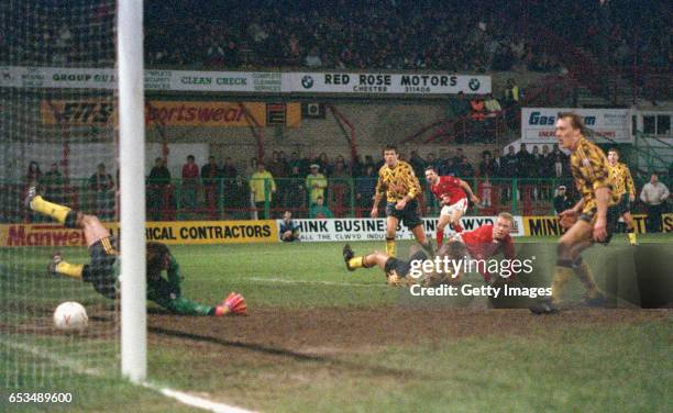 Wrexham striker Steve Watkin scores the winning goal past David Seaman watched by left to right, David O' Leary, Tony Adams Gordon Davies and Lee...