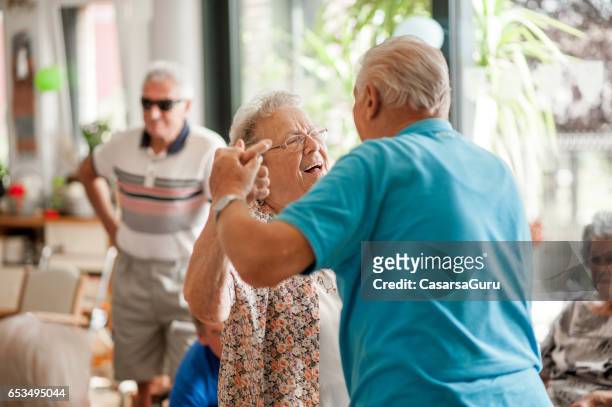 seniors having fun in the community center - community activity stock pictures, royalty-free photos & images