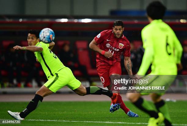 Shanghai SIPG' Brazilian forward Hulk kicks the ball past Urawa Red Diamonds' defender Tomoaki Makinovie during the AFC Asian Champions League group...
