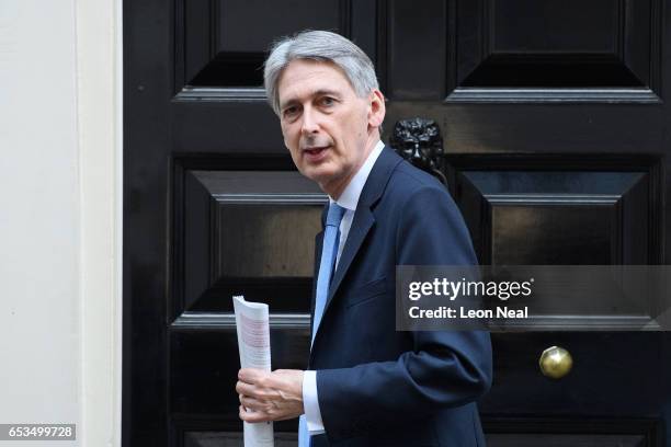 British Chancellor Philip Hammond leaves number 11, Downing Street as he makes his way to the House of Commons on March 15, 2017 in London, England....