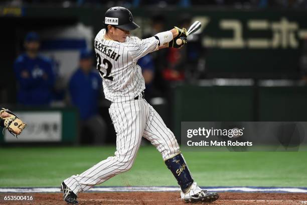 Catcher Seiji Kobayashi of Japan hits a RBI single to make it 0-3 in the bottom of the sixth inning during the World Baseball Classic Pool E Game Six...