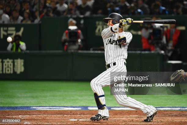 Catcher Seiji Kobayashi of Japan hits a RBI single to make it 0-3 in the bottom of the sixth inning during the World Baseball Classic Pool E Game Six...