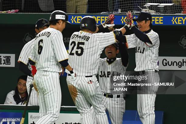 Outfielder Yoshitomo Tsutsugoh of Japan celebrates hitting a solo homerun with head coach Hiroki Kokubo to make it 0-1 in the bottom of the sixth...