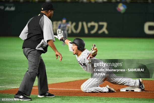 Infielder Nobuhiro Matsuda of Japan reacts after sliding safely on the third base in the bottom of the sixth inning during the World Baseball Classic...