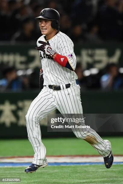 Infielder Hayato Sakamoto of Japan scores a run by a RBI double of Infielder Nobuhiro Matsuda to make it 0-2 in the bottom of the sixth inning during...