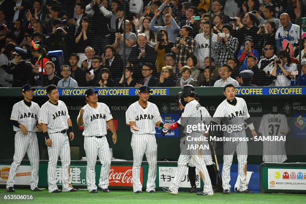 Infielder Hayato Sakamoto of Japan celebrates with his team mates after scoring a run by a RBI double of Infielder Nobuhiro Matsuda to make it 0-2 in...