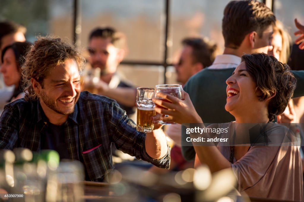 Happy couple having drinks at a bar