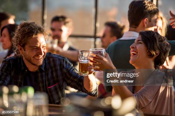 happy couple having drinks at a bar - couple fine dining imagens e fotografias de stock