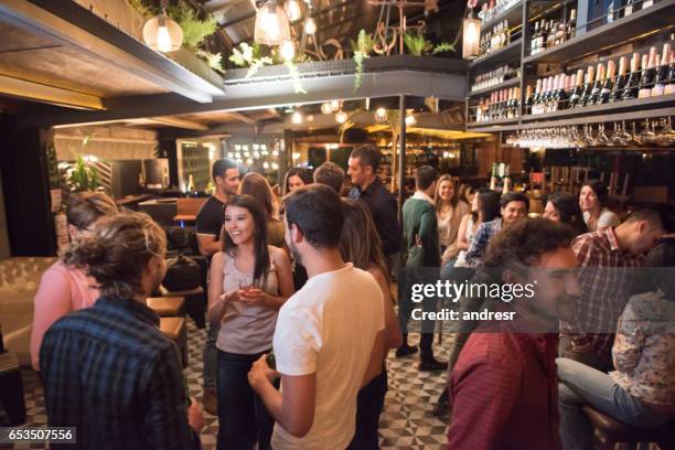 people having drinks at a bar - reunion social gathering stock pictures, royalty-free photos & images