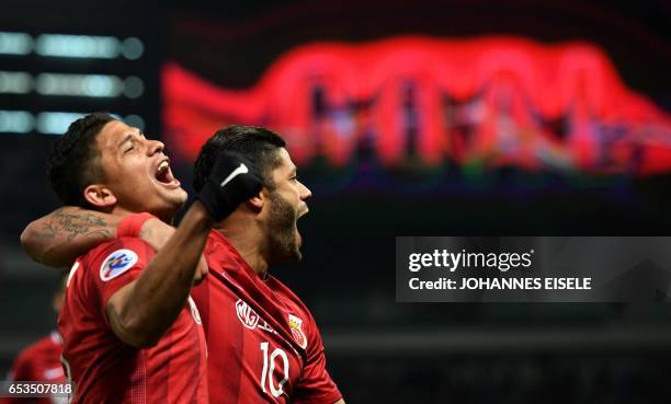 Shanghai SIPG' Brazilian forward Hulk and teammate Elkeson celebrate a goal during the AFC Asian Champions League group football match between...