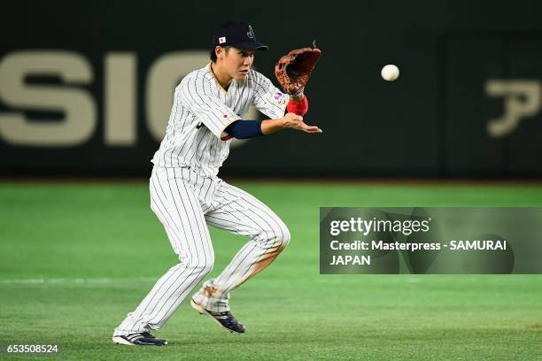 Infielder Hayato Sakamoto of Japan fields a grounder by Infielder Tyler Krieger of Israel in the top of the eighth inning during the World Baseball...