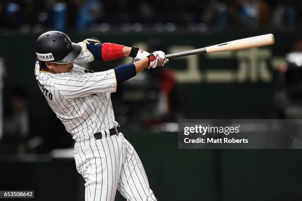 Infielder Hayato Sakamoto of Japan hits a sinle in the bottom of the seventh inning during the World Baseball Classic Pool E Game Six between Israel...