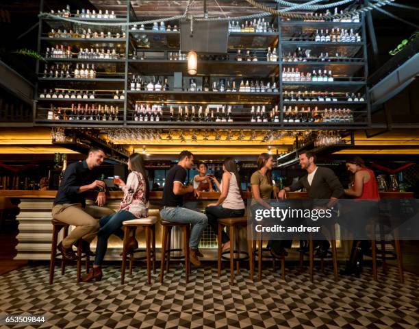 people having drinks at a bar - counter stock pictures, royalty-free photos & images
