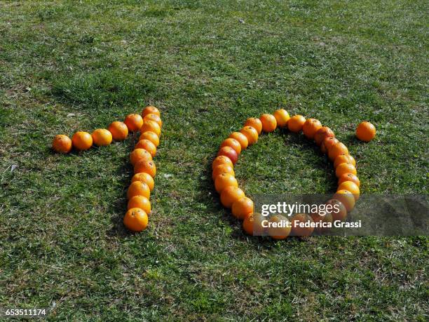 number ten written with orange fruits - season 10 stock-fotos und bilder