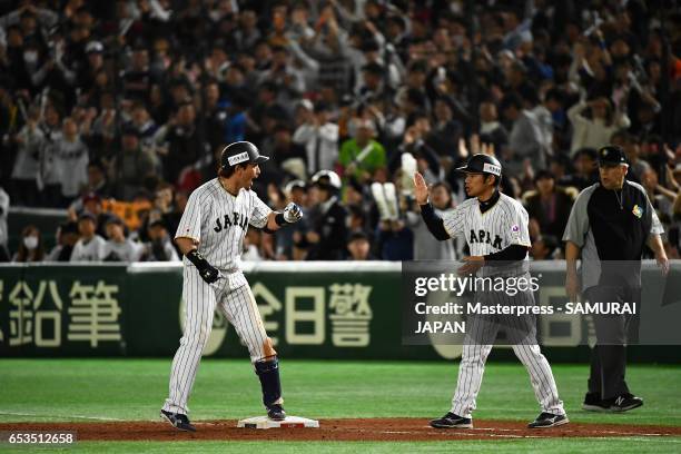 Infielder Nobuhiro Matsuda of Japan celebrates with coach Toshihisa Nishi after hitting a RBI single to make it 0-8 in the bottom of the eighth...