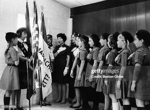 Girl Scouts participate in the flag ceremony at the new Bay Path Colonial Council offices at 381 Elliot St. In Newton, Mass., April 1964. From left...