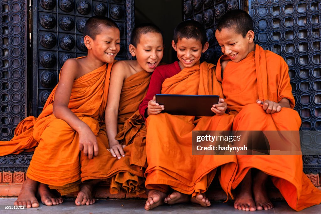 Novice Buddhist monks using digital tablet, Bhaktapur