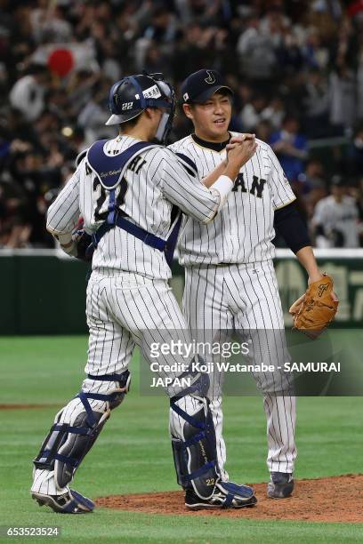 Pitcher Kazuhisa Makita and Catcher Seiji Kobayashi of Japan celebrate after their win in the World Baseball Classic Pool E Game Six between Israel...