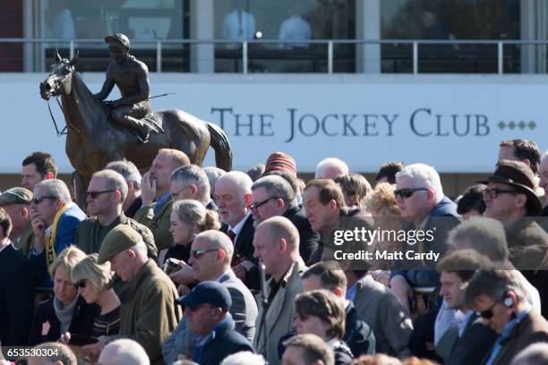 Racegoers gather to study the horses at the Cheltenham Racecourse on Ladies Day, the second day of the Cheltenham Festival on March 15, 2017 in...