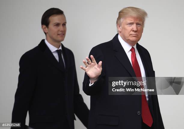 President Donald Trump waves while walking to a waiting Marine One helicopter with son-in-law and senior advisor Jared Kushner while departing the...