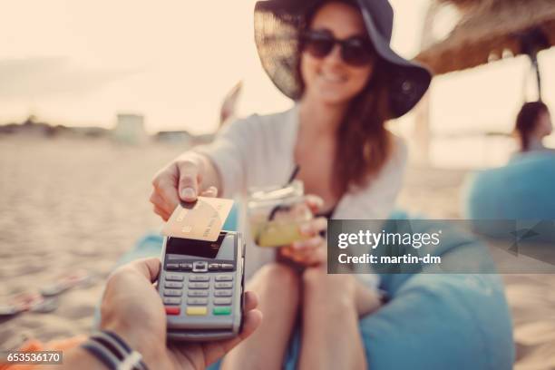 woman paying contactless with credit card - sun lounger stock pictures, royalty-free photos & images