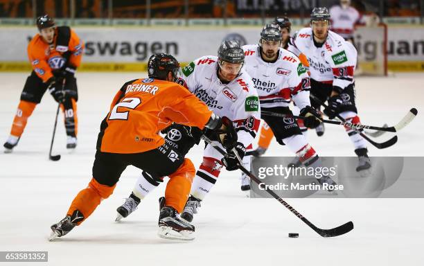 Jeremey Dehner of the Grizzlys Wolfsburg challenges Alexandre Bolduc of Koelner Haie during the DEL Playoffs Quarter Final Game 4 between the...